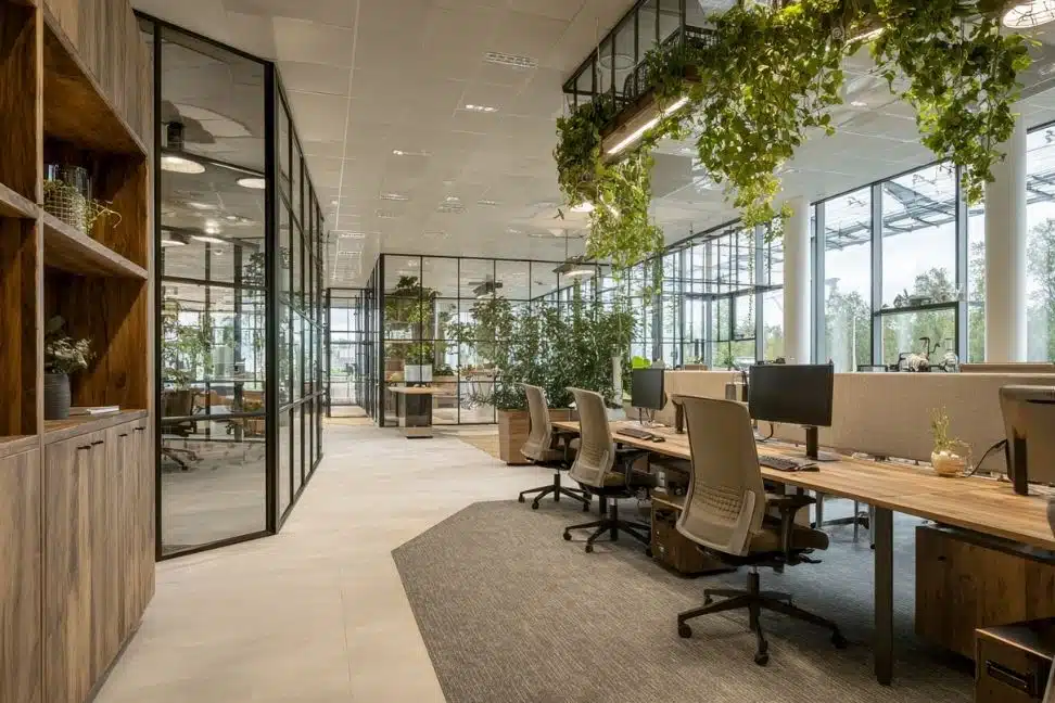 Moderne kantoorinrichting op maat met systeemplafond, glazen wanden en veel groen